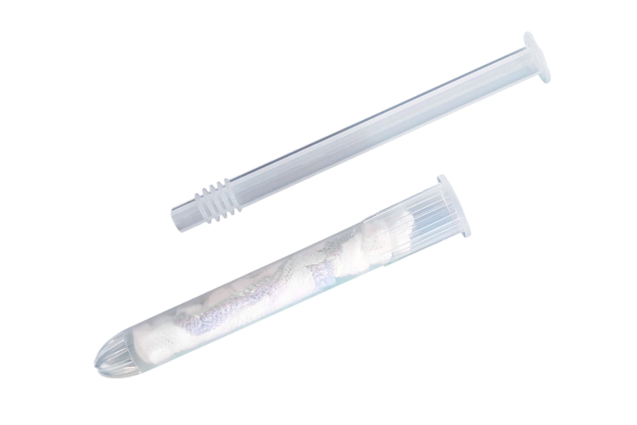 A clear plastic syringe-style applicator tube shown open with a minisponge pouch inside, photographed on a plain white background.